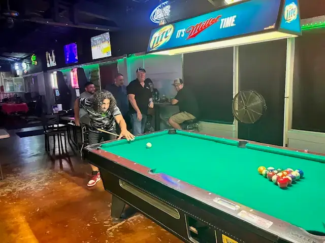 People Playing Pool in Bar Area